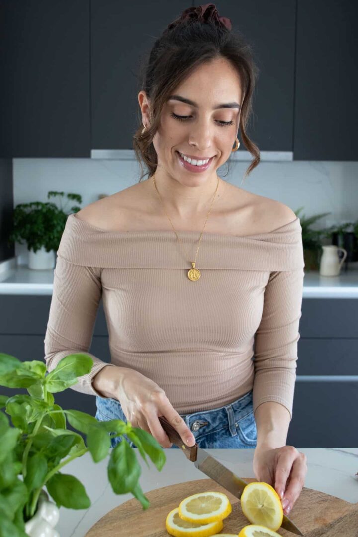 Rita cutting a lemon on a chopping board