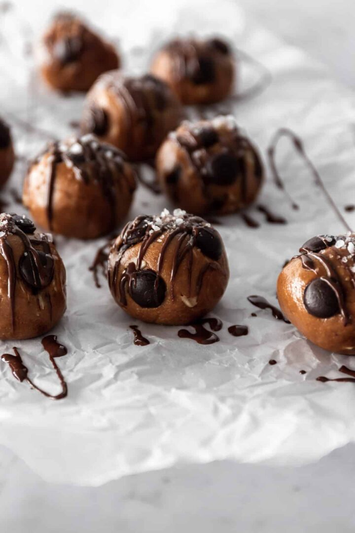 close up peanut butter balls with chocolate chips and sprinkled salt on top