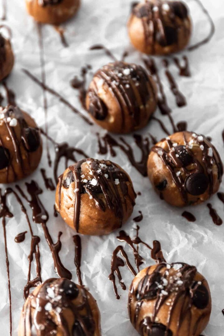 close up peanut butter balls with chocolate chips and sprinkled salt on top