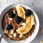 quinoa chocolate bowl with banana, flaked almonds and blackberries