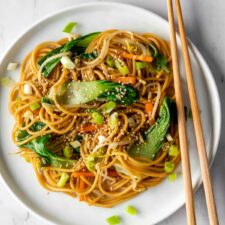 Vegetable lo mein on a plait with chopsticks on the side