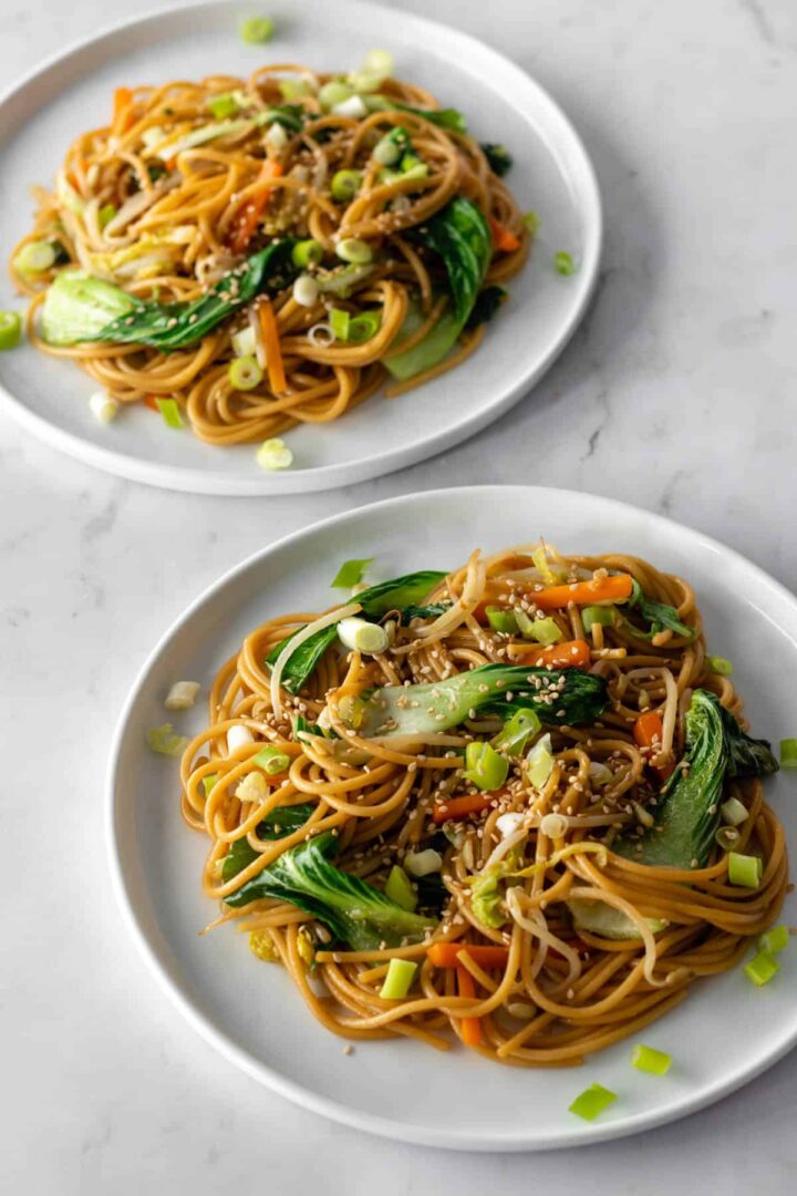 Vegetable lo mein served on two plates