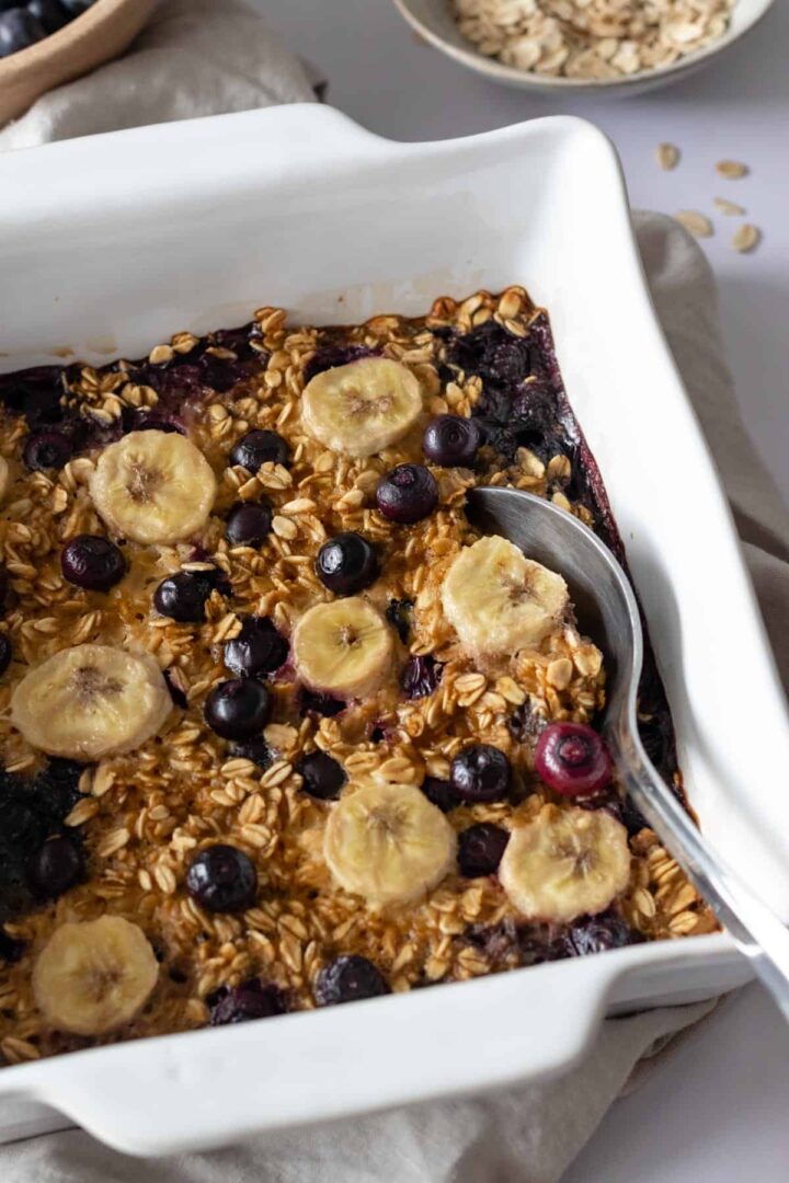 blueberry oatmeal on s baking dish with a spoon on the side