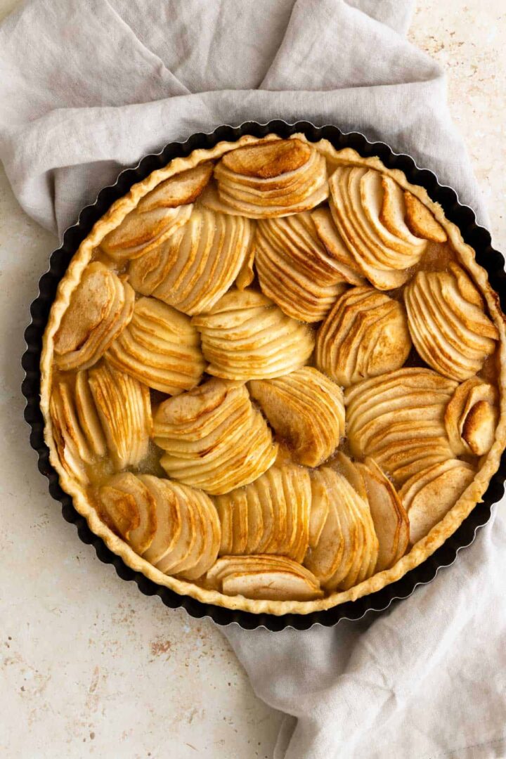 french apple tart on top of a kitchen towel