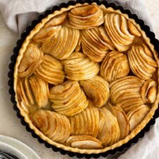 french apple tart on top of a kitchen towel