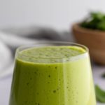 a glass with green smoothie