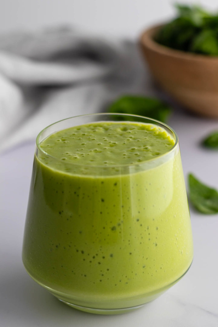 a glass with a green smoothie