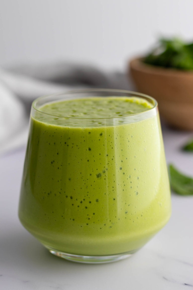 a glass with green smoothie