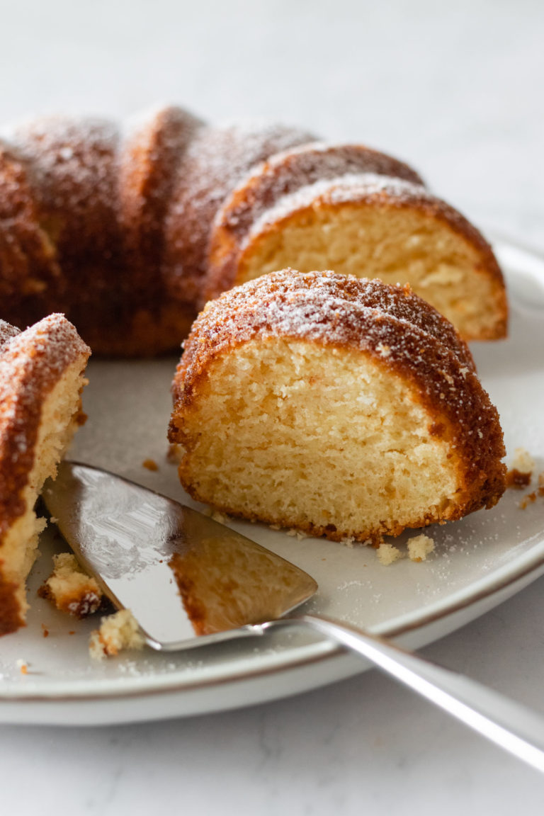 a plate with a sliced cake and a serving utensil