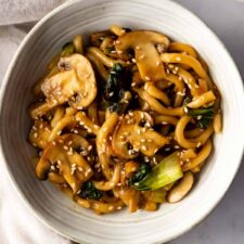 close up of a bowl with Yaki Udon noodles garnished with sesame seeds