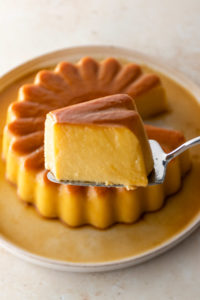 close up of a slice of coconut flan