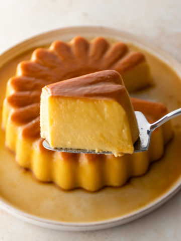close up of a slice of coconut flan