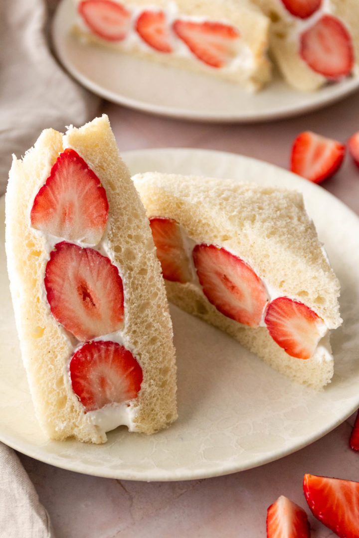 halves of sandwich with whipped cream and strawberries