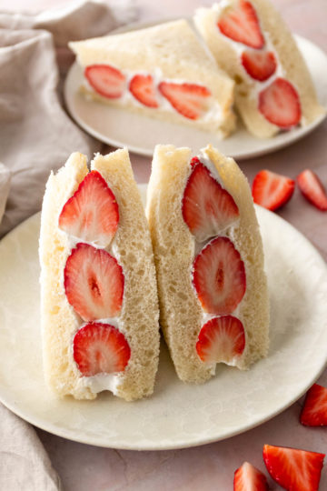 two whipped cream strawberry sandwiches