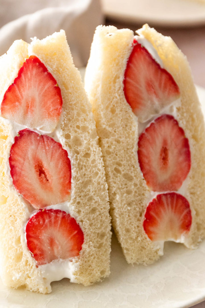 close up of halves of Japanese fruit sandwich with whipped cream and strawberries