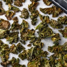 kale chips on a baking tray after going to the oven