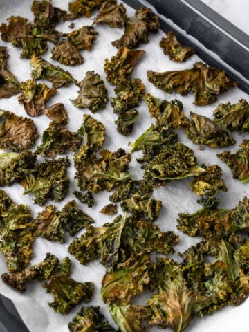 kale chips on a baking tray after going to the oven