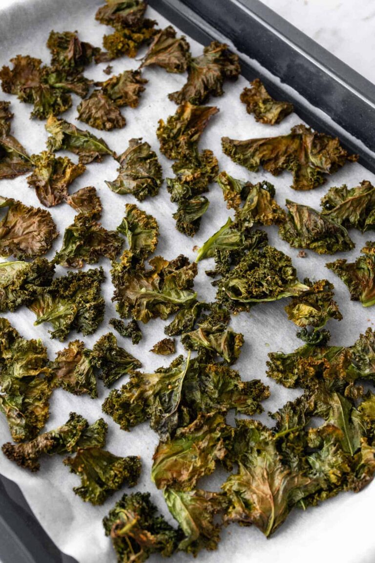 kale chips on a baking tray after going to the oven
