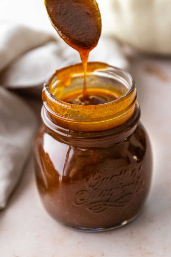 A glass jar with pumpkin spice syrup
