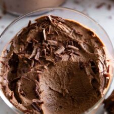 close up of avocado chocolate mousse with chocolate shavings on top