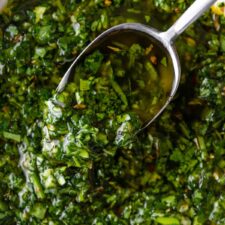 a spoon and a bowl with chimichurri sauce
