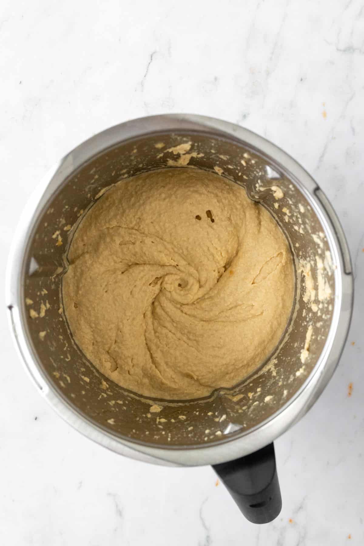 hummus inside the thermomix mixing bowl after being blended