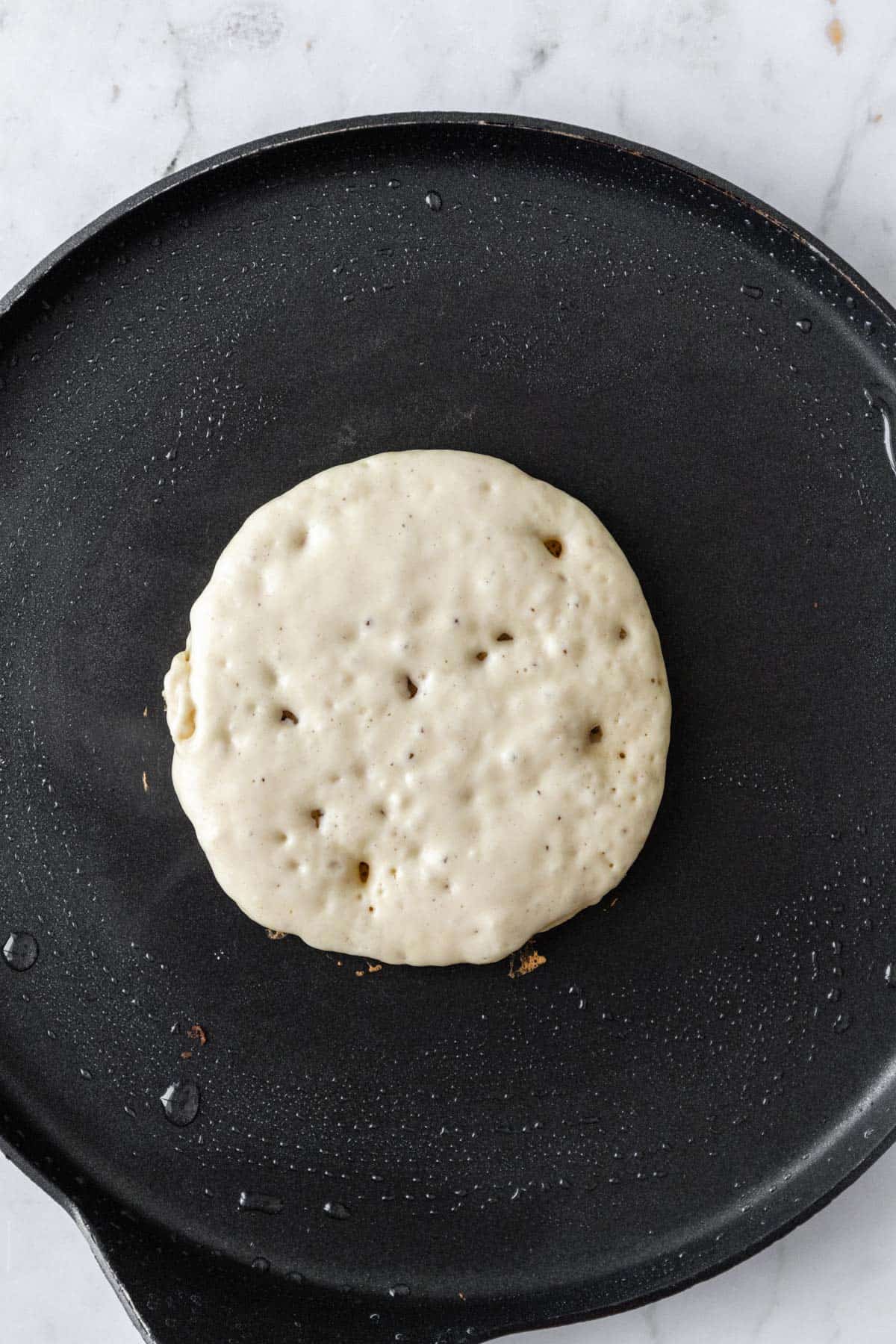 a pancake skillet with batter on top.