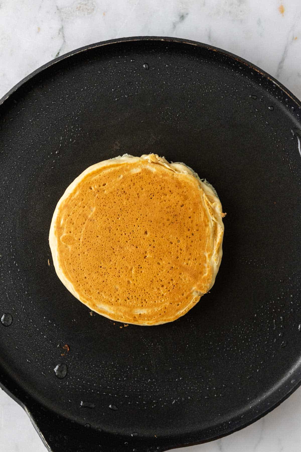 a pancake skillet with one pancake on top