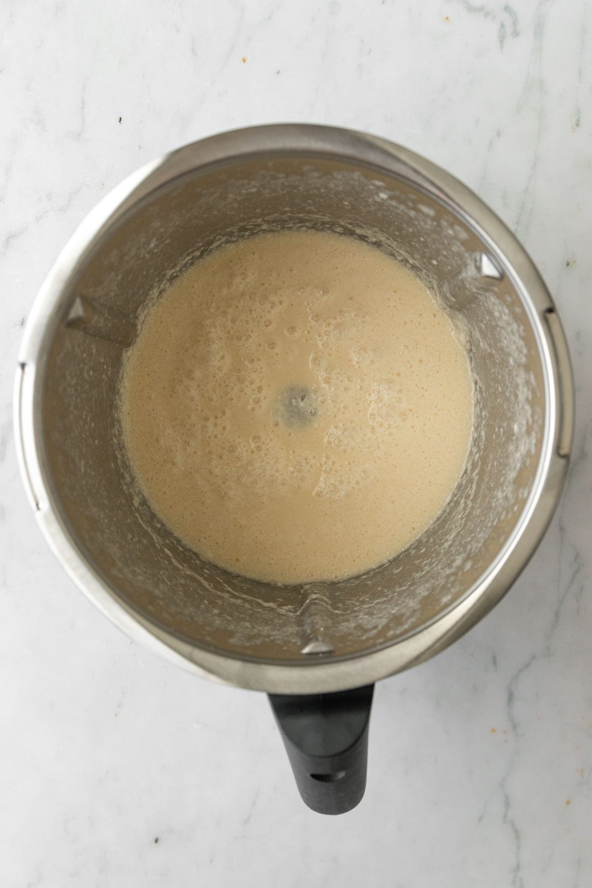 a Thermomix mixing bowl with muffin batter inside