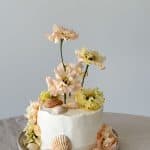 a cake decorated with flowers on a table